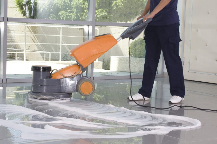 a worker is cleaning the floor with equipment